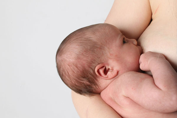 Father holding baby in skin-to-skin contact