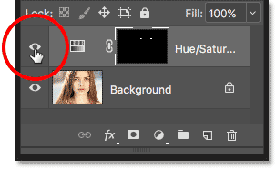 Clicking the layer visibility icon for the Hue/Saturation adjustment layer.