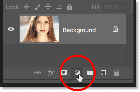 Clicking the New Fill or Adjustment Layer icon in the Layers panel in Photoshop.