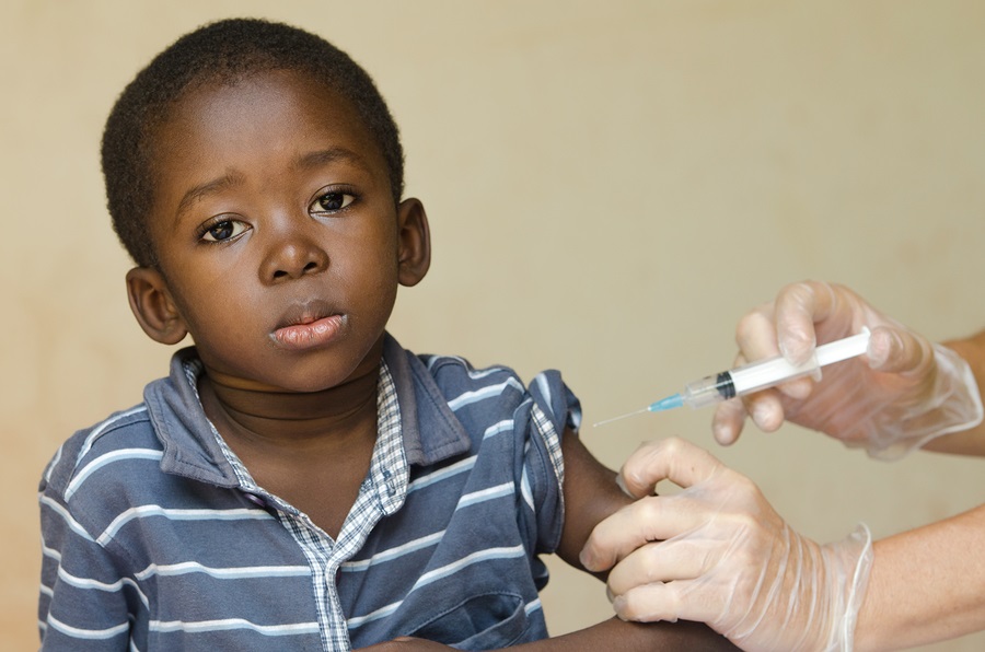 Close-up of a little black African ethnicity boy getting a medical injection as a vaccination. 